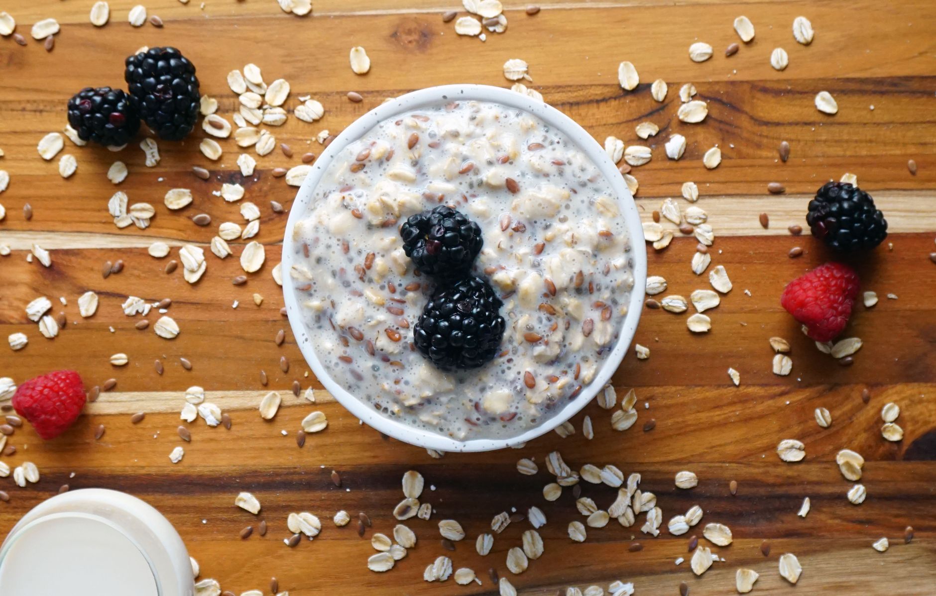 a bowl of oatmeal with berries and raspberries