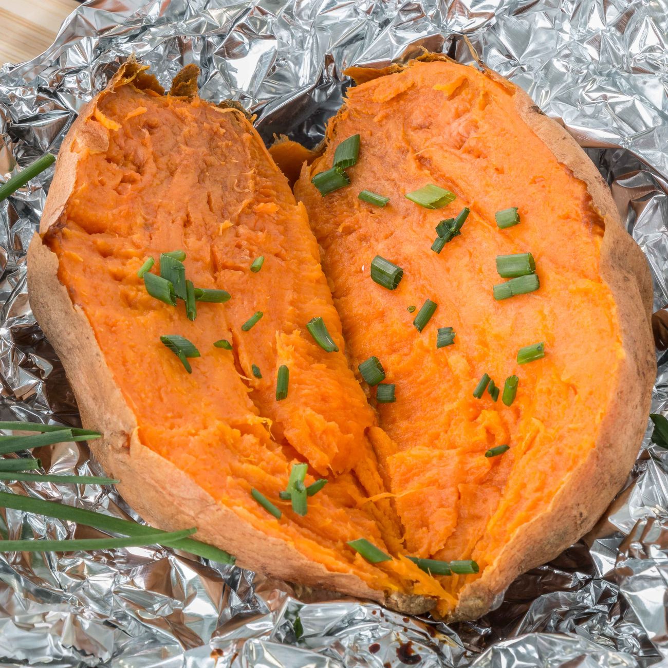 cooked sweet potato with chopped chives